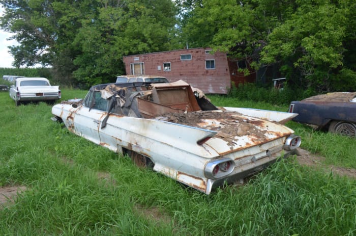  Another white Cadillac convertible in the stash up for auctions is this 1961 Series 62. There is also an equally rough red 1961 convertible. This white car sold for $3600.