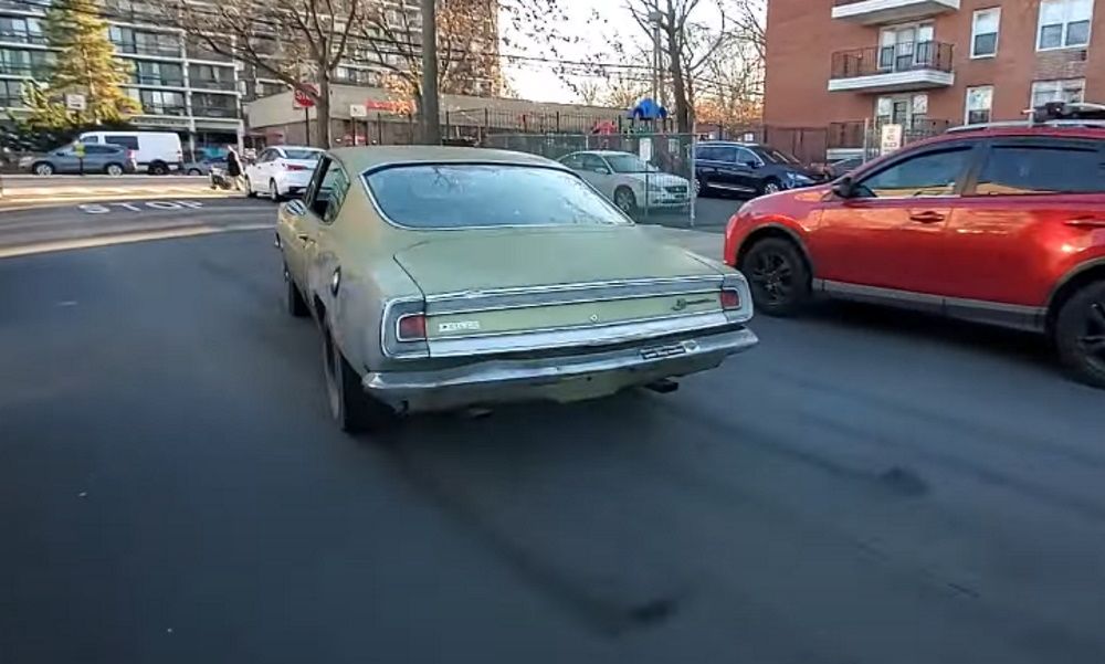 A 1968 Plymouth Barracuda Formula S burns rubber on a Brooklyn street