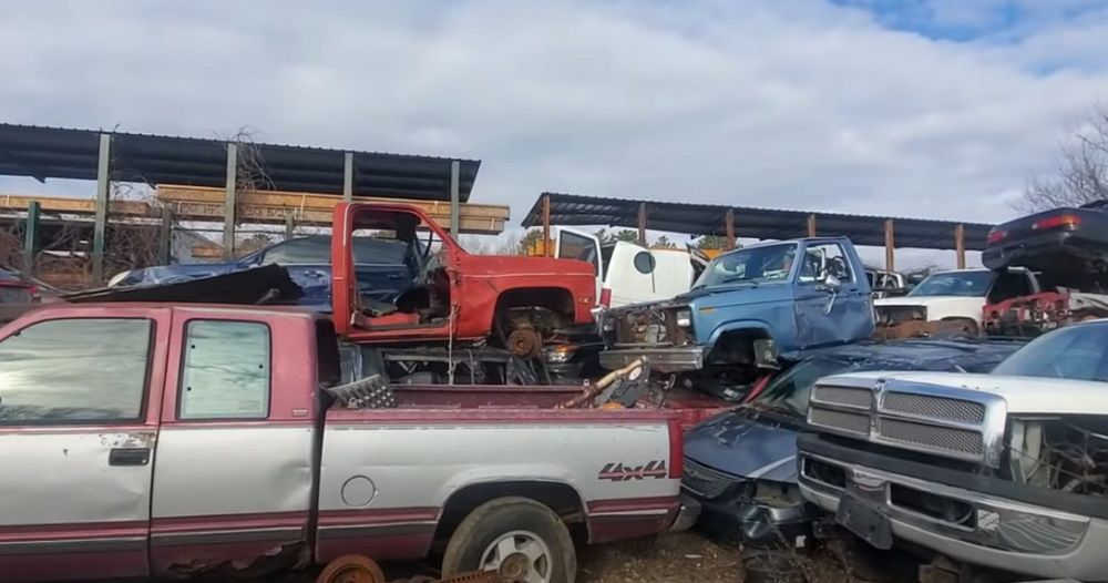 GM, Dodge, and Ford trucks at a Long Island junkyard