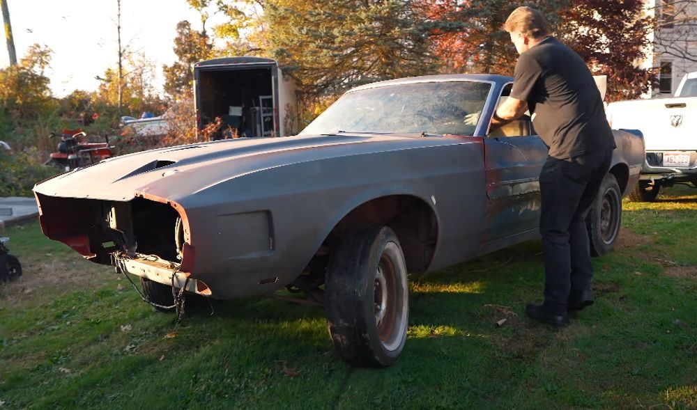 Towing away a 1969 Shelby GT350, man next to car